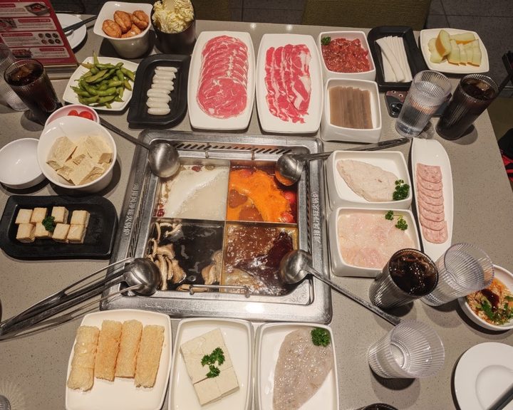 Four-section hot pot with sliced meats, tofu and vegetables at Haidilao at The O2