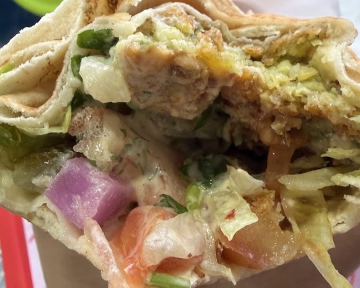 A freshly filled falafel wrap at Mr Falafel in Shepherd’s Bush Market