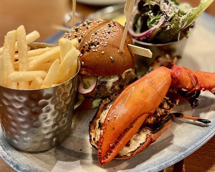 Grilled lobster, burger, fries and salad at Burger and Lobster Knightsbridge