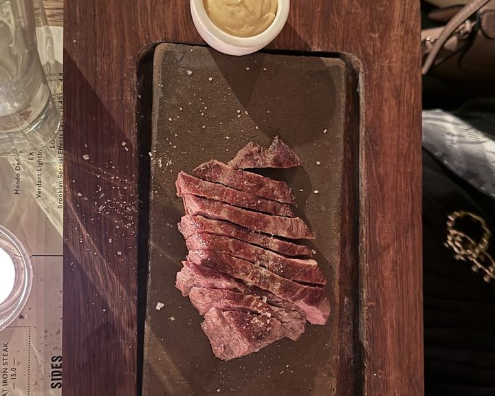 Sliced steak and sides at Flat Iron Marylebone