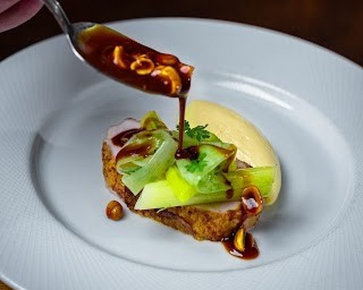 A precisely plated seasonal meat course with sauce at Thomas, the brasserie in Pontcanna
