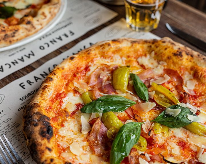 Sourdough pizzas with colourful toppings at Franco Manca Cardiff