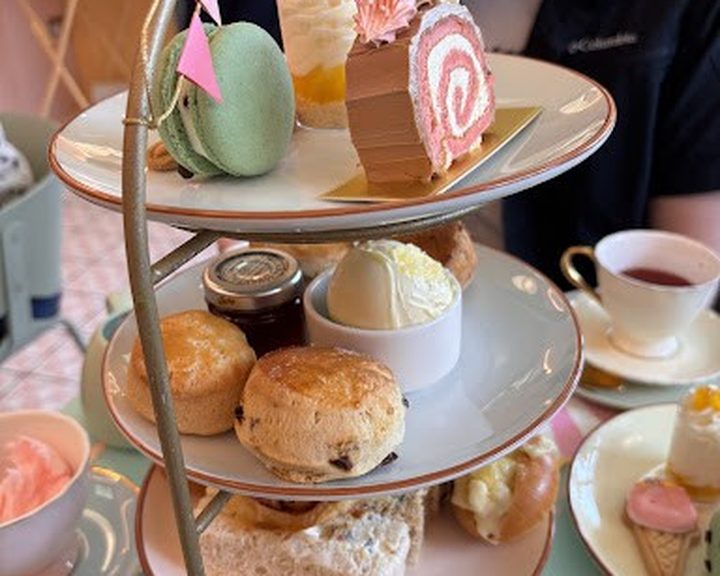 An afternoon tea stand of cakes and savouries at Let Them See Cake in Cardiff