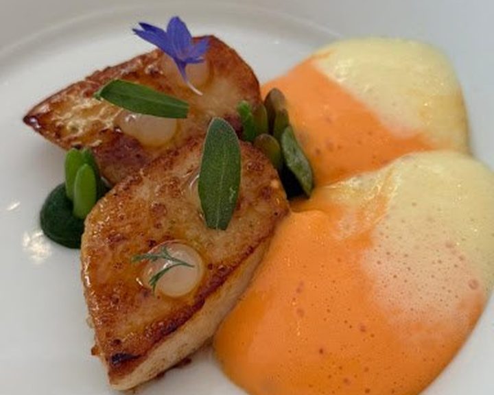 Seared scallops with peas and sauces at Petrus by Gordon Ramsay