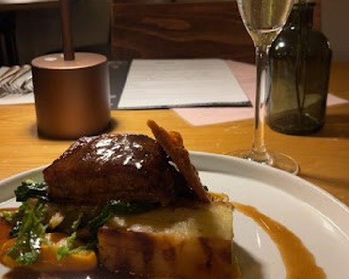 A glazed meat main course with potato and vegetables at The Potted Pig in Cardiff