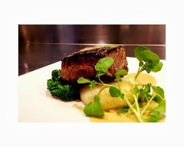 Seared fish with greens and lemon at The Wet Fish Cafe in West Hampstead