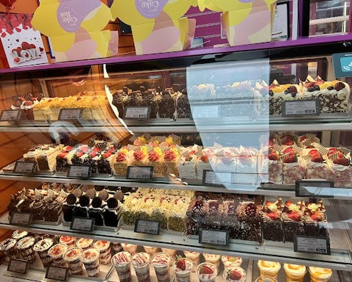 A colourful display of cake slices at Cake Box Canton in Cardiff