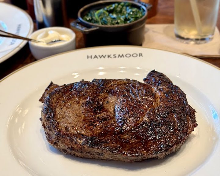 Charcoal-grilled steak and sides at Hawksmoor Wood Wharf