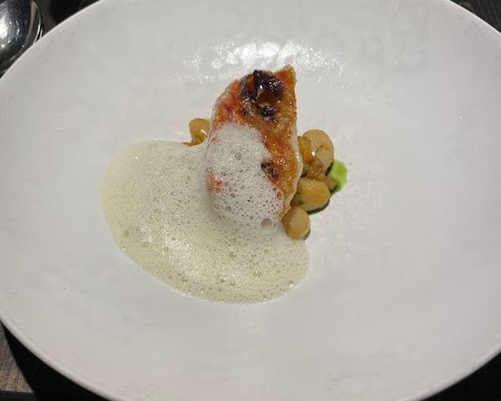 A finely plated fish course with a light sauce at Heaneys in Cardiff
