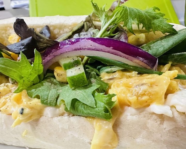 A freshly filled baguette with salad and egg at 16 La Baguette in Cardiff