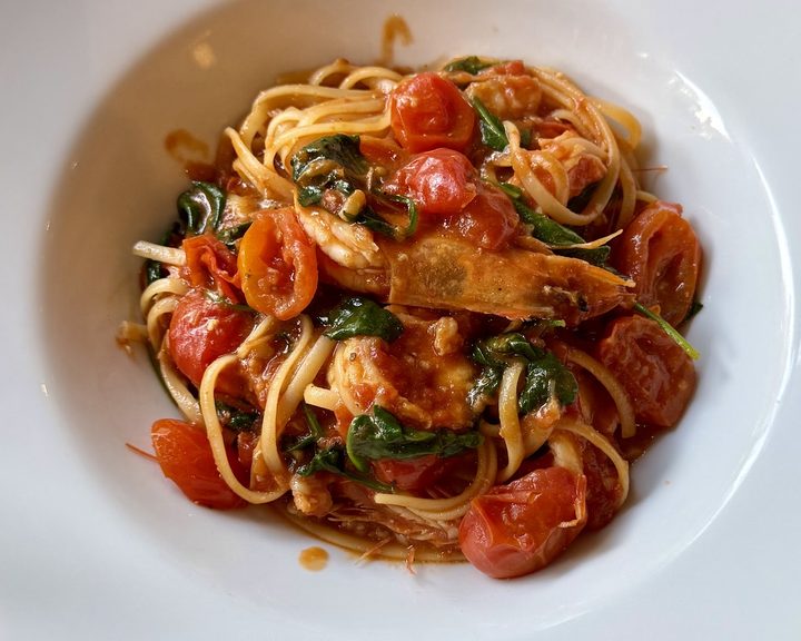 Seafood pasta with tomatoes and herbs at Pizzeria Pappagone