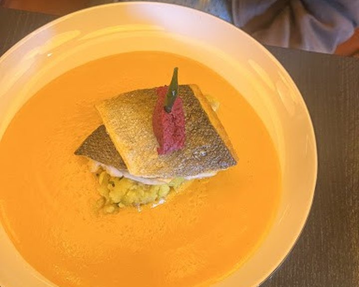 A contemporary Indian fish dish with a crisp garnish at Purple Poppadom in Canton