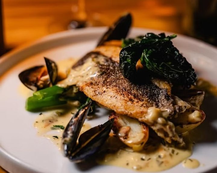 Pan-fried fish with mussels, potatoes and greens at The Potted Pig