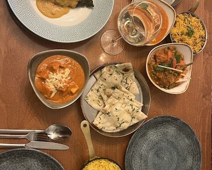An overhead spread of curries and naan at The Prahna