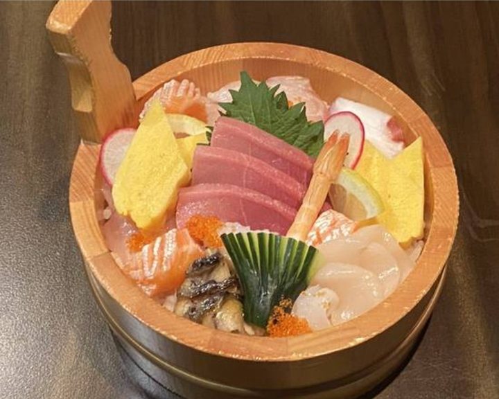 Sashimi arranged in a wooden bowl at Hoshi Raynes Park