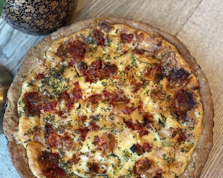 A golden savoury tart with salad at Snails Delicatessen in Rhiwbina