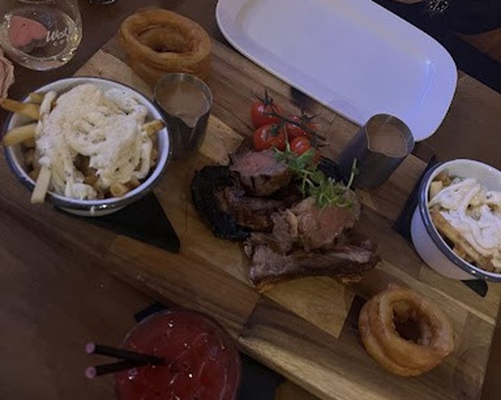 Steak, onion rings and sides at The Whitefort in Andersonstown