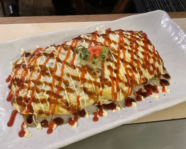 Okonomiyaki cooking on the hotplate at Abeno
