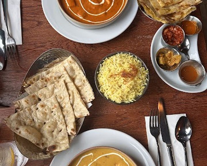 Curries, rice and flatbreads arranged at Gautam's in Edinburgh