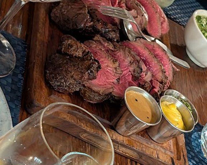 Sliced steak with sauces at High Timber beside the Thames