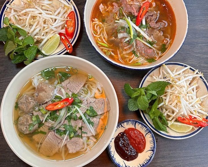 Bowls of Vietnamese pho with herbs and chilli at Hoi An Bruntsfield