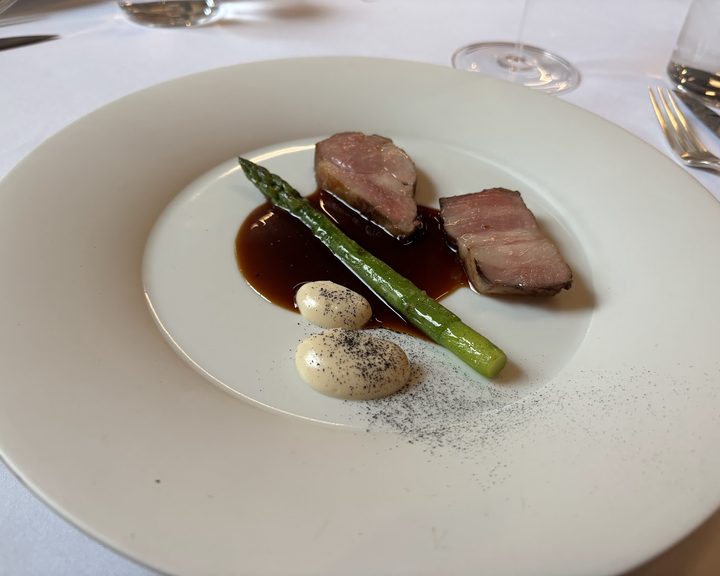 Fine-dining meat course with asparagus and sauce at Cycene