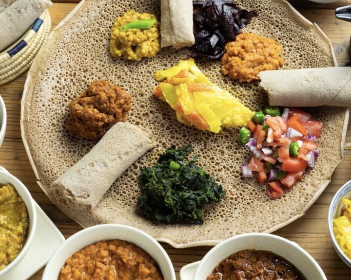 Ethiopian and Eritrean stews arranged on injera at Delina