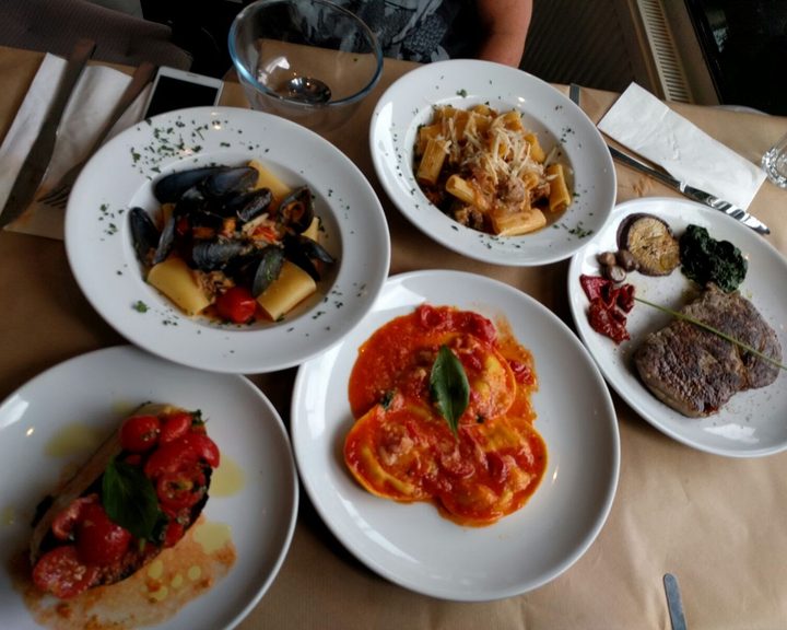 A spread of pasta, burrata, vegetables and meat at Osteria Tufo