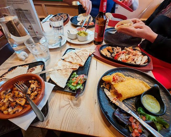 Venezuelan dishes and sides spread across a table at Sabor Criollo