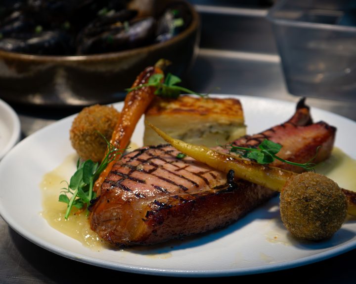 A grilled pork dish with vegetables at The Phoenix in North Belfast