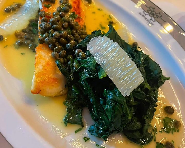 Fish with capers, greens and sauce at The Wolseley City