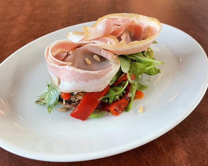 An open sandwich with cured ham and peppers at Wally's Kaffeehaus