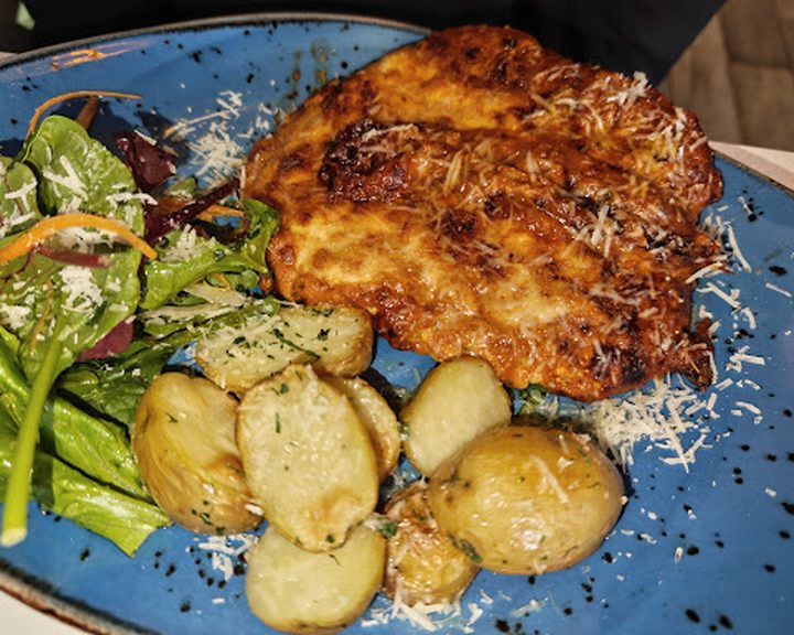 A crisp fish dish with potatoes and greens at Fish City Belfast