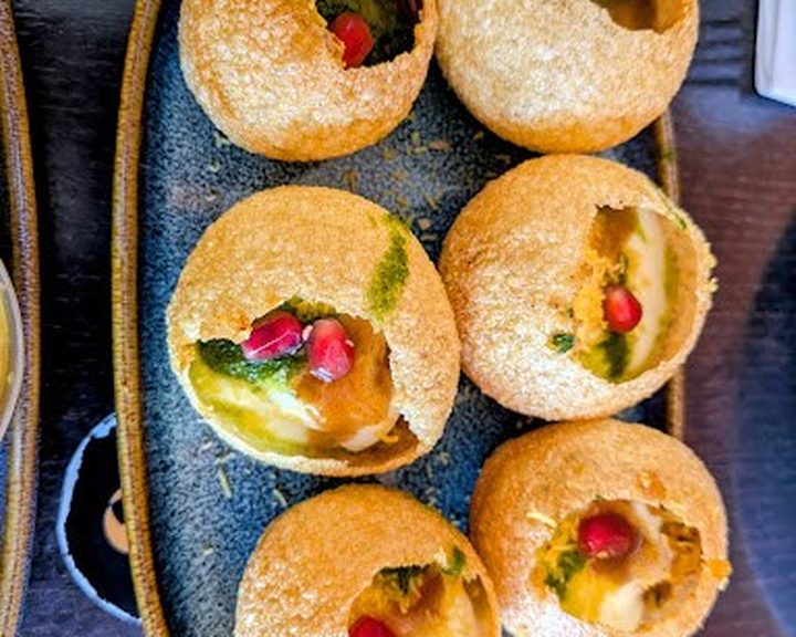Crisp dahi puri filled with chutney and pomegranate at Hullabaloo Greenwich