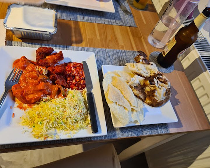 An Indian meal with rice and grilled dishes at Indian Knights Belfast