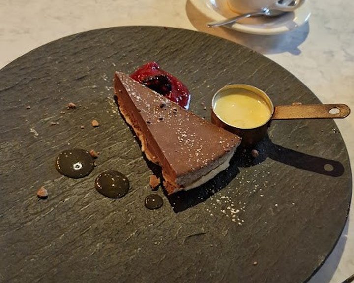 A chocolate dessert with fruit and custard at The Sorting Room in Cardiff