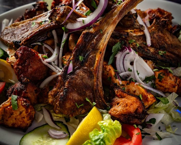 Grilled lamb chops and chicken souvlaki with salad at Andromeda Restaurant