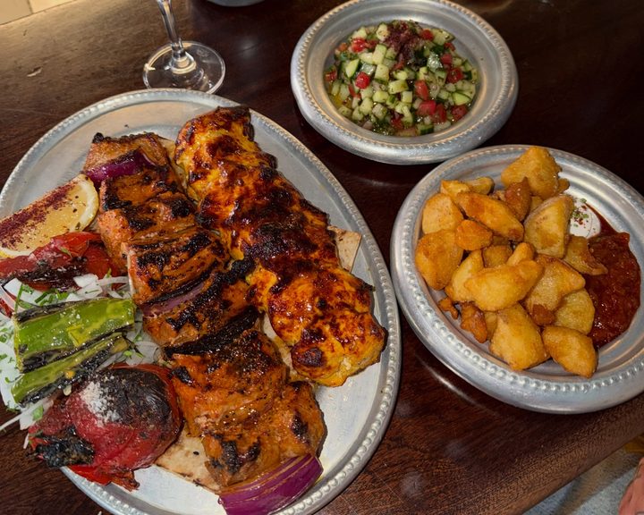 Grilled chicken, potatoes and Shirazi salad at Berenjak Soho