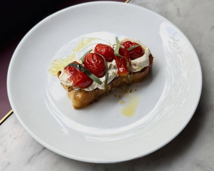 Ricotta, confit garlic and roast tomatoes on toast at Noble Rot