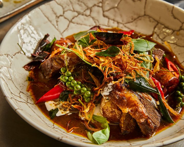 A richly dressed Thai dish with herbs and vegetables shared by Farang chef Sebby Holmes