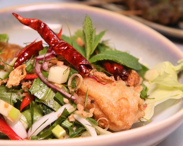Crispy vegan salmon with fresh herbs at Mali Vegan Thai