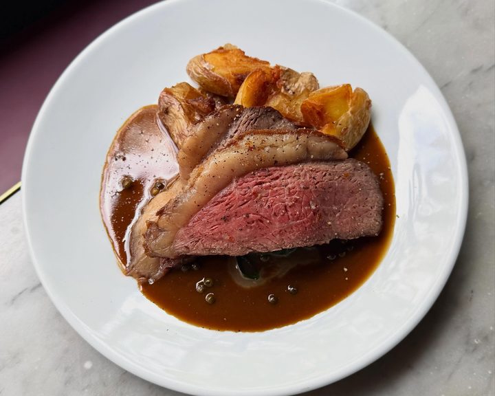 Roast beef rump with fried potatoes and peppercorn sauce at Noble Rot Lamb’s Conduit