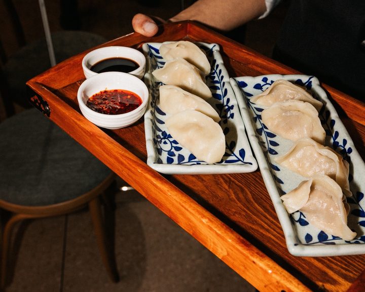 Assorted dumplings served on a wooden tray at Noodle and Beer Spitalfields
