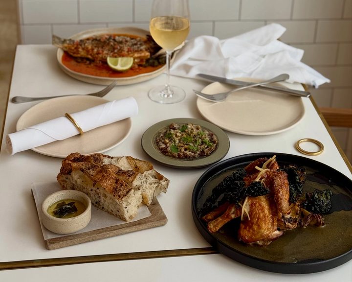 Seasonal sharing dishes and bread on a table at NOPI