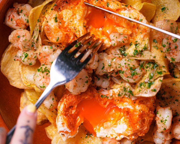 Garlic prawns with fried eggs and crisps at Sabor in London