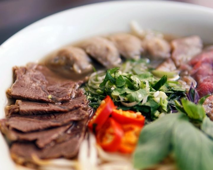 Beef pho with sliced meat and fresh herbs at Viet Soho