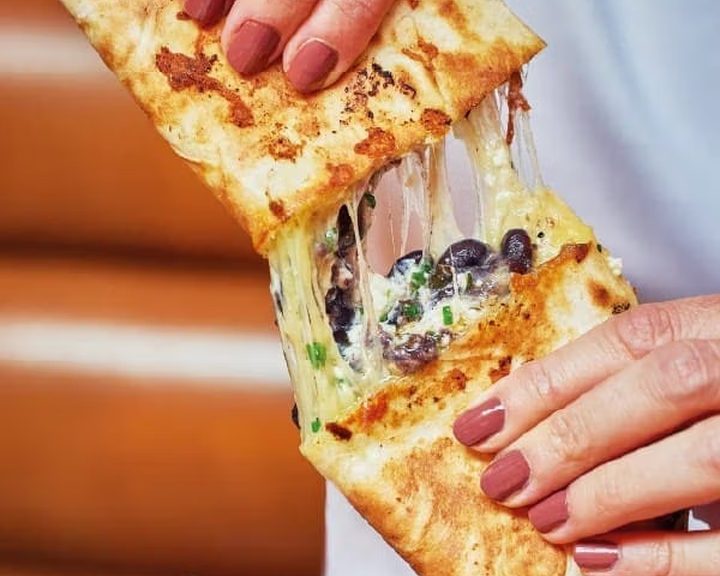 Golden quesadilla with fresh garnish from Wahaca